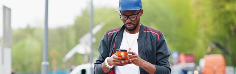 Man-scheduling-a-bill-payment-on-his-cell-phone-using-his-money-management-tools-while-out-and-about-on-his-cell-phone