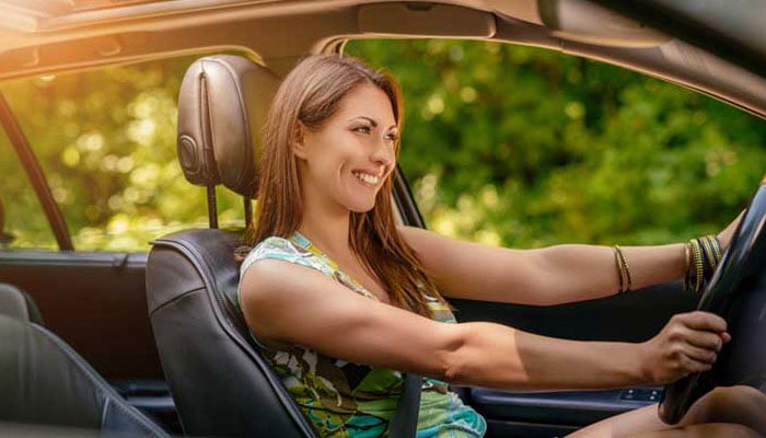  A-pre-approved-car-loan-helps-you-leave-your-memorial-day-car-sale-happy-like-this-woman-driving-her-new-car. 