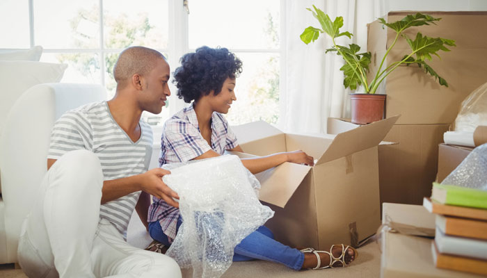  Young-couple-unpacking-moving-boxes-after-their-FHA-Loan-helped-secure-their-first-mortgage. 