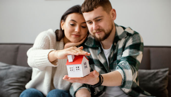  This couple is getting ready to buy their first home using our tips.  