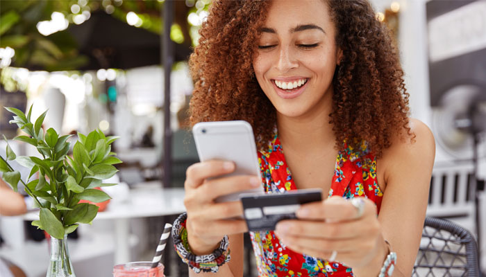 Young lady safely making-an-online-purchase-using-her-credit-card.