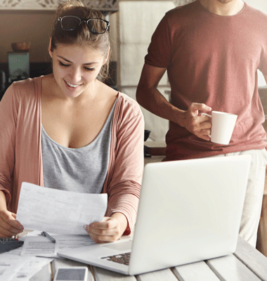 young-pretty-woman-wearing-glasses-her-head-smiling-happily-while-reading-document-saying-that-bank-approved-their-mortgage-application
